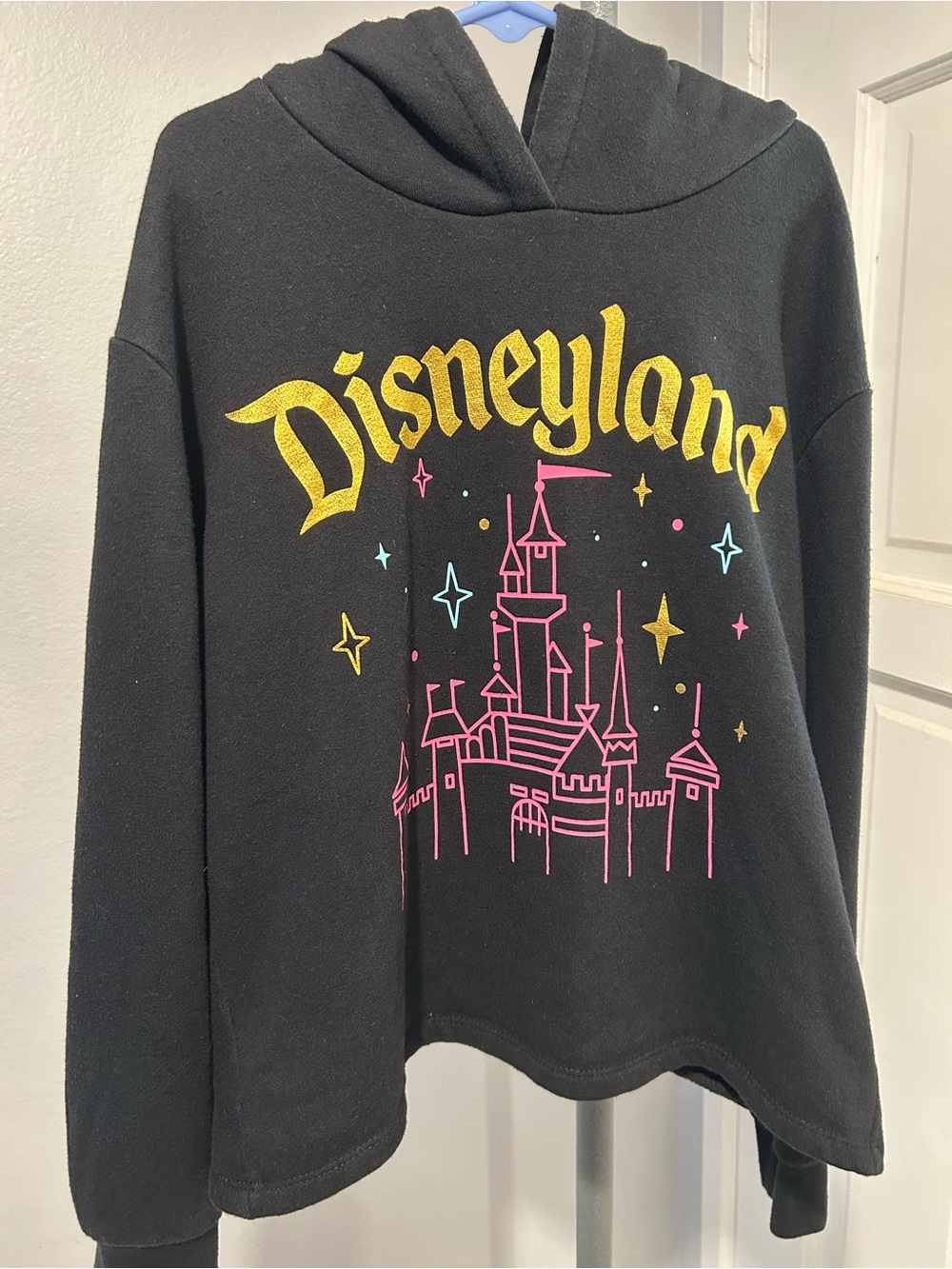 Disney Black Hoodie with Yellow Disneyland Text and Pink Castle Graphic